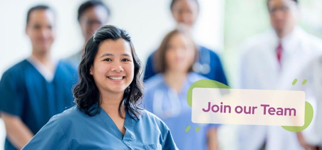 A Nurse in the foreground with several nurses behind her. They are looking for someone to join their team.
